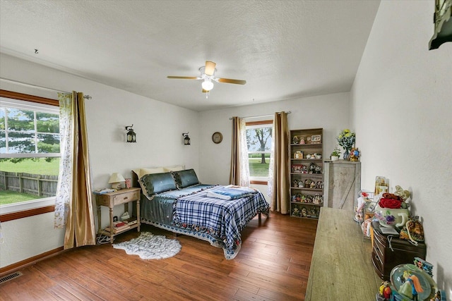 9101 US Highway 36, Metcalf, IL 61940 - bedroom with wood-type flooring, ceiling fan, and a textured ceiling