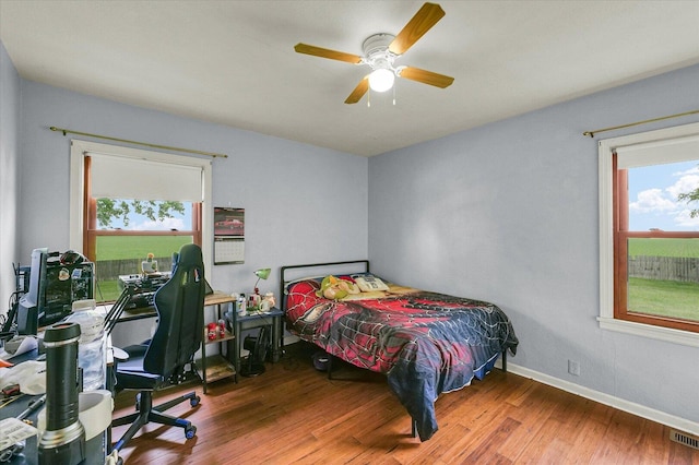 9101 US Highway 36, Metcalf, IL 61940 - bedroom with multiple windows, wood finished floors, and a ceiling fan