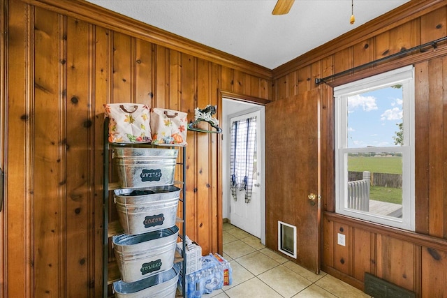 9101 US Highway 36, Metcalf, IL 61940 - entryway featuring healthy amount of natural light, light tile patterned flooring, wood walls, crown molding, and ceiling fan