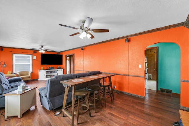 9101 US Highway 36, Metcalf, IL 61940 - living room with arched walkways, a ceiling fan, crown molding, wood finished floors, and a textured ceiling