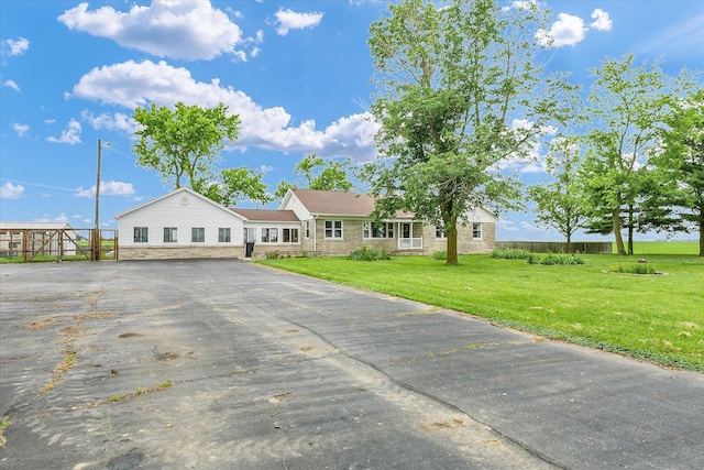 9101 US Highway 36, Metcalf, IL 61940 - single story home featuring stone siding, asphalt driveway, and a front yard