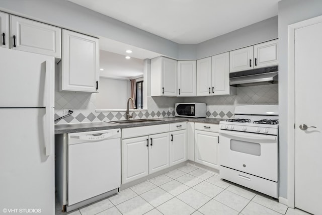 2336 N Commonwealth Ave Unit 108, Chicago, IL 60614 - kitchen featuring white appliances, under cabinet range hood, dark countertops, white cabinets, and tasteful backsplash