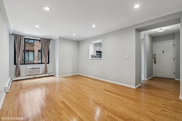 2336 N Commonwealth Ave Unit 108, Chicago, IL 60614 - empty room featuring light wood-style floors, recessed lighting, crown molding, a wall mounted air conditioner, and baseboard heating