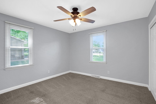 717 Bittersweet Ln, New Lenox, IL 60451 - spare room with dark carpet and a ceiling fan
