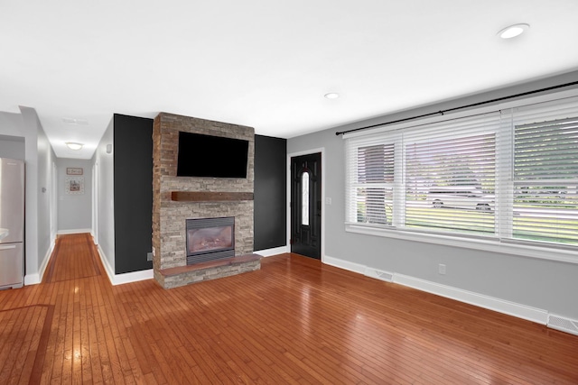 717 Bittersweet Ln, New Lenox, IL 60451 - unfurnished living room with hardwood / wood-style floors, a fireplace, and recessed lighting