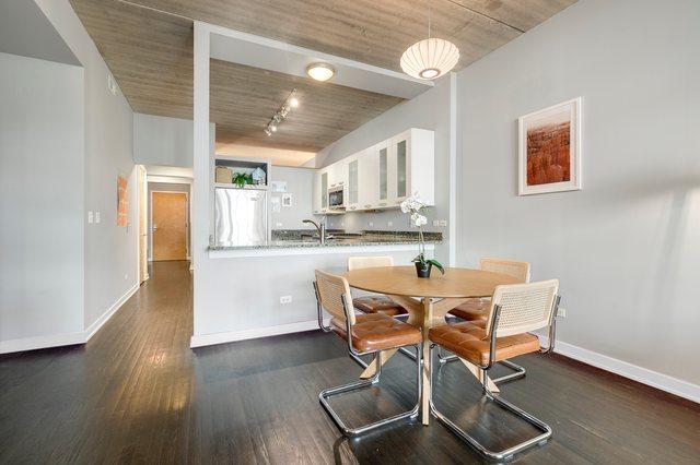 5430 N Sheridan Rd Unit 403, Chicago, IL 60640 - dining space featuring dark wood-style flooring and track lighting