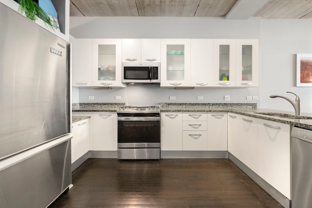 5430 N Sheridan Rd Unit 403, Chicago, IL 60640 - kitchen with stainless steel appliances, white cabinets, light stone counters, and dark wood-type flooring