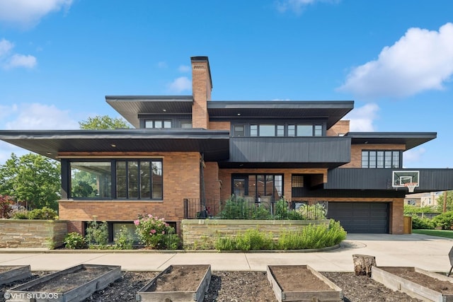 9333 S Oakley Ave, Chicago, IL 60643 - view of front facade featuring a garden, concrete driveway, a garage, brick siding, and a chimney