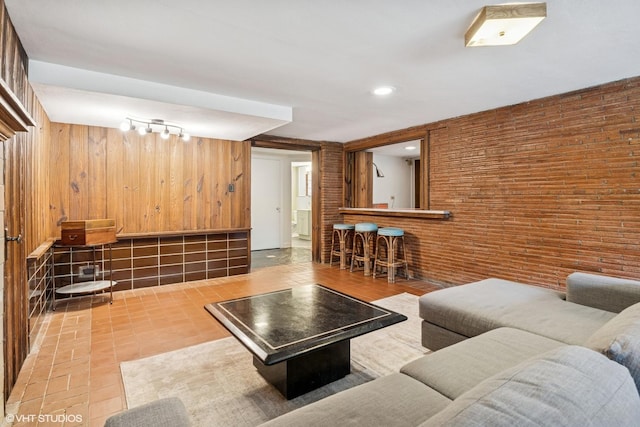 9333 S Oakley Ave, Chicago, IL 60643 - tiled living area with wooden walls, a bar, and track lighting