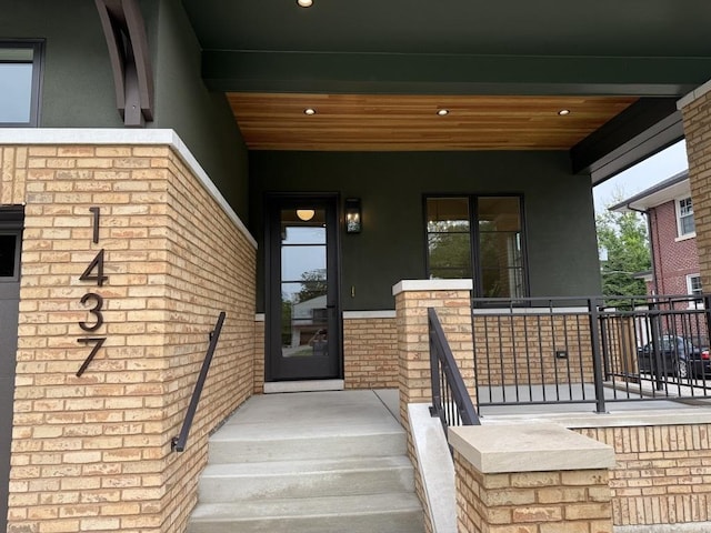 1437 Ashland Ave, River Forest, IL 60305 - view of exterior entry featuring stucco siding, a porch, and brick siding