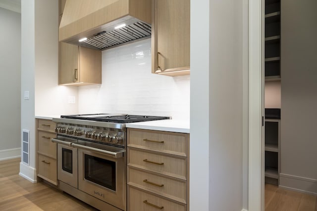 1437 Ashland Ave, River Forest, IL 60305 - kitchen with range with two ovens, custom exhaust hood, light brown cabinets, light countertops, and light wood-style floors