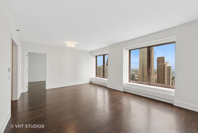 161 E Chicago Ave Unit 40G, Chicago, IL 60611 - empty room with dark wood-style flooring and baseboards