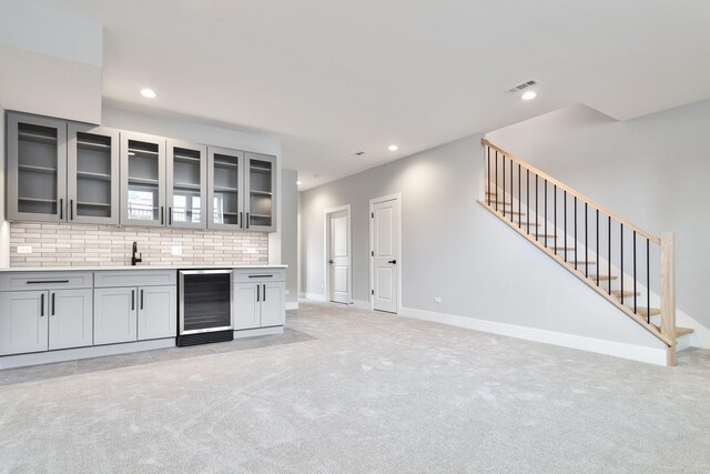 3452 N Central Ave, Chicago, IL 60634 - indoor wet bar featuring wine cooler, stairway, recessed lighting, light colored carpet, and backsplash