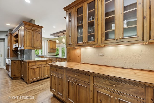 1310 Gavin Ct, Lake Forest, IL 60045 - kitchen featuring light wood finished floors, brown cabinets, wood counters, recessed lighting, and glass insert cabinets