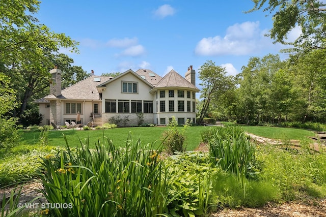 1310 Gavin Ct, Lake Forest, IL 60045 - rear view of property featuring stucco siding, a chimney, a yard, and a sunroom