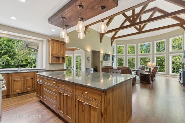 1310 Gavin Ct, Lake Forest, IL 60045 - kitchen with high vaulted ceiling, arched walkways, brown cabinets, plenty of natural light, and recessed lighting