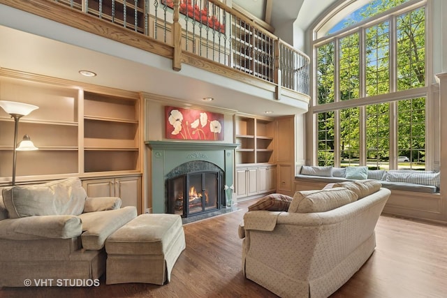 1310 Gavin Ct, Lake Forest, IL 60045 - living area with a high end fireplace, a towering ceiling, wood finished floors, and built in shelves