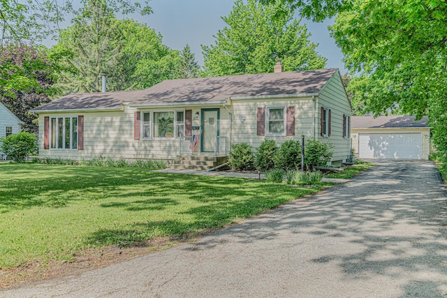716 Kirkwood Ave, Winthrop Harbor, IL 60096 - view of front of house featuring entry steps, a chimney, a front yard, a detached garage, and an outbuilding