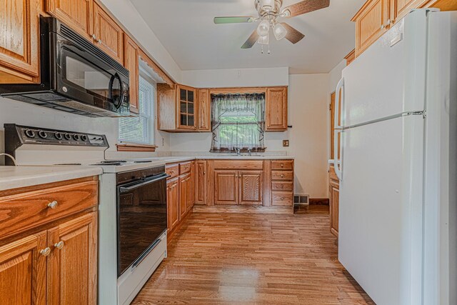 716 Kirkwood Ave, Winthrop Harbor, IL 60096 - kitchen featuring white appliances, light wood-type flooring, light countertops, and a ceiling fan
