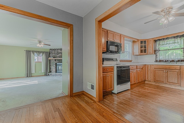 716 Kirkwood Ave, Winthrop Harbor, IL 60096 - kitchen featuring black microwave, white range with electric stovetop, ceiling fan, and light wood-type flooring