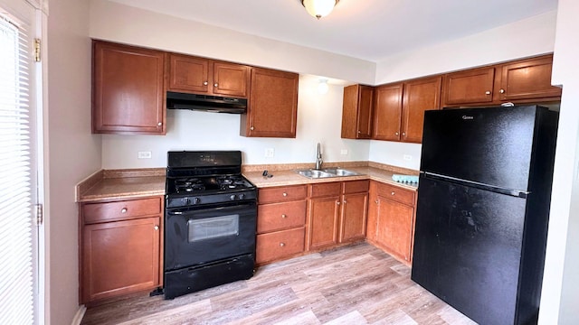 6024 Beechwood Rd, Matteson, IL 60443 - kitchen featuring black appliances, under cabinet range hood, light wood finished floors, and brown cabinets