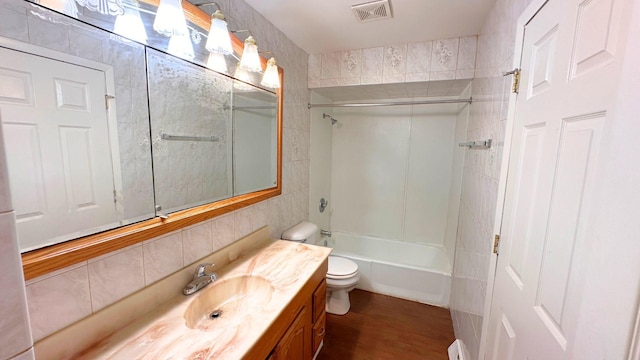 6024 Beechwood Rd, Matteson, IL 60443 - bathroom featuring vanity, wood finished floors, shower / washtub combination, and tile walls