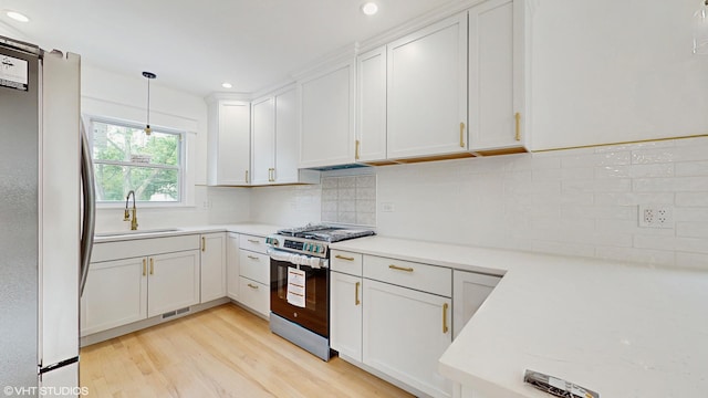 15230 State St, South Holland, IL 60473 - kitchen with stainless steel appliances, light countertops, white cabinets, recessed lighting, and light wood-style floors