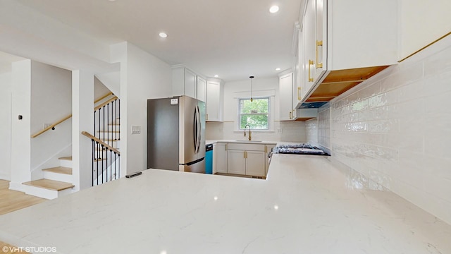 15230 State St, South Holland, IL 60473 - kitchen featuring freestanding refrigerator, backsplash, light stone countertops, range, and decorative light fixtures