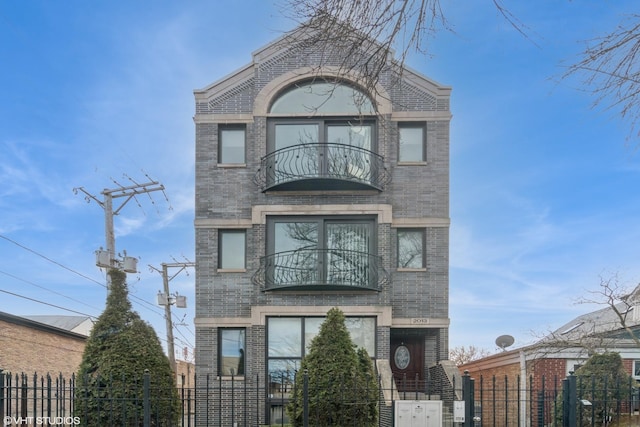 2013 W Rice St Unit 3, Chicago, IL 60622 - view of front of home with a balcony, brick siding, and a fenced front yard