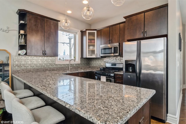 2013 W Rice St Unit 3, Chicago, IL 60622 - kitchen featuring stainless steel appliances, open shelves, dark brown cabinetry, a peninsula, and recessed lighting