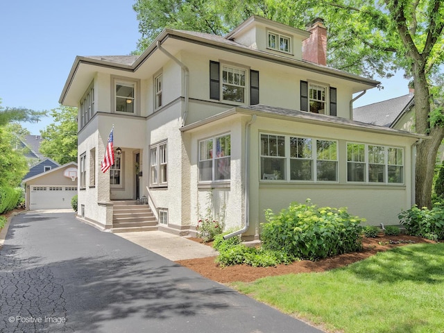 132 S Spring Ave, La Grange, IL 60525 - view of front facade with stucco siding, a chimney, a garage, and an outdoor structure