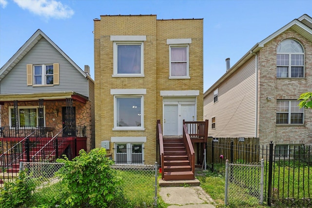 1318 S Kolin Ave, Chicago, IL 60623 - view of front of home featuring stairs, brick siding, and a fenced front yard