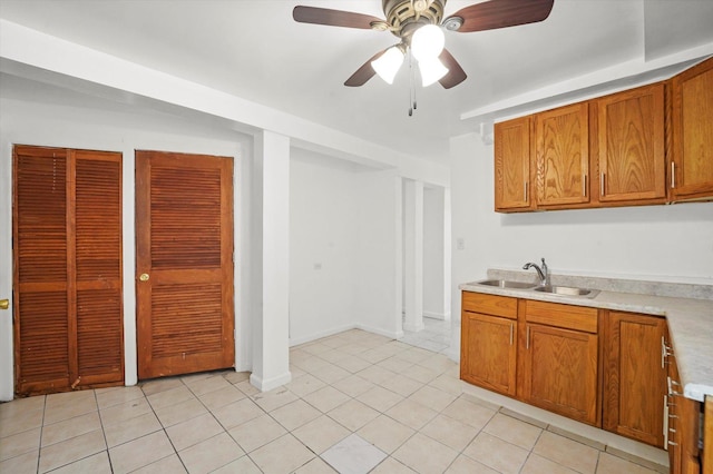 1318 S Kolin Ave, Chicago, IL 60623 - kitchen featuring brown cabinetry, light countertops, ceiling fan, and light tile patterned floors