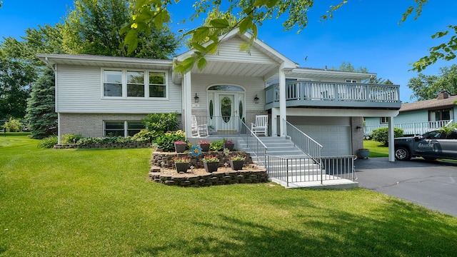 70 Delburne Dr, Davis, IL 61019 - split foyer home with asphalt driveway, a garage, a front lawn, and brick siding