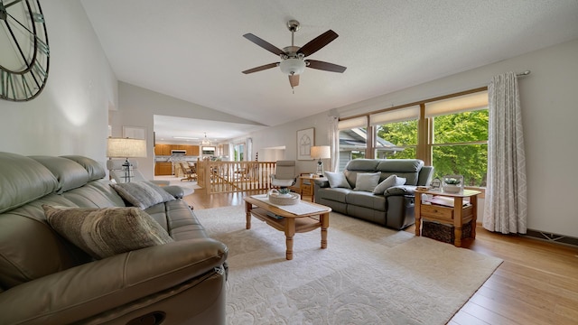70 Delburne Dr, Davis, IL 61019 - living room with ceiling fan, healthy amount of natural light, vaulted ceiling, wood finished floors, and a chandelier