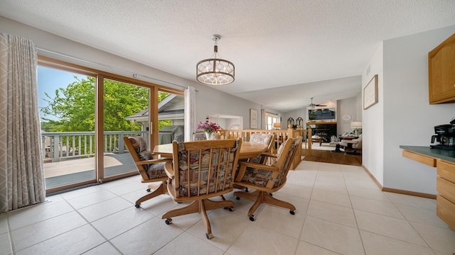 70 Delburne Dr, Davis, IL 61019 - dining room featuring a chandelier, a textured ceiling, a ceiling fan, and light tile patterned floors