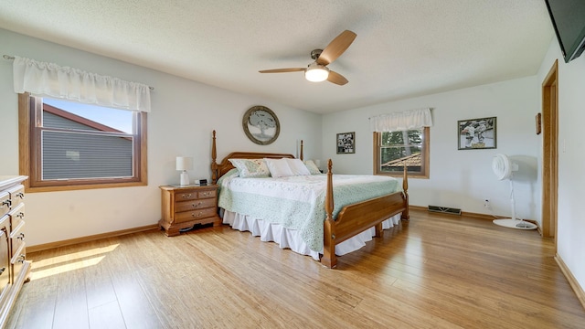 70 Delburne Dr, Davis, IL 61019 - bedroom featuring light wood-type flooring, a textured ceiling, and ceiling fan