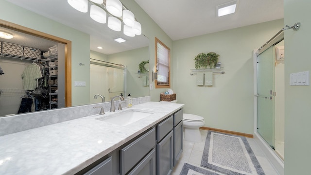 70 Delburne Dr, Davis, IL 61019 - bathroom featuring vanity, a stall shower, a walk in closet, and tile patterned flooring