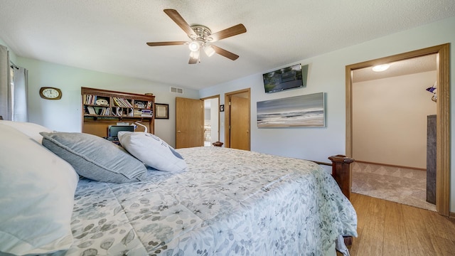 70 Delburne Dr, Davis, IL 61019 - bedroom featuring light wood finished floors, a ceiling fan, and a textured ceiling