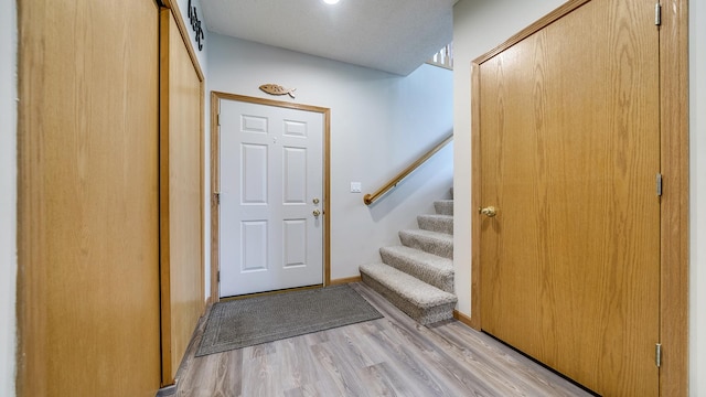 70 Delburne Dr, Davis, IL 61019 - entryway with stairway and light wood-style flooring