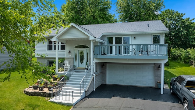 70 Delburne Dr, Davis, IL 61019 - raised ranch with a balcony, a garage, brick siding, and a front lawn