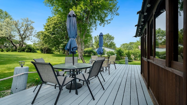70 Delburne Dr, Davis, IL 61019 - wooden deck with outdoor dining area and a yard