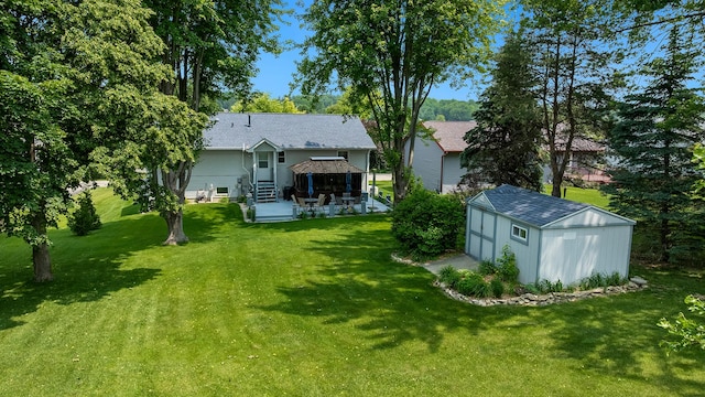 70 Delburne Dr, Davis, IL 61019 - back of property featuring a shed, a yard, and a shingled roof