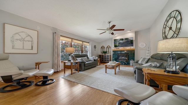 70 Delburne Dr, Davis, IL 61019 - living area featuring a ceiling fan, lofted ceiling, wood finished floors, and a tile fireplace