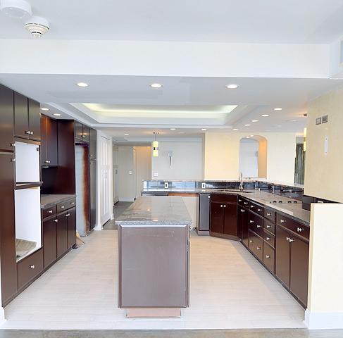405 N Wabash Ave Unit 5109, Chicago, IL 60611 - kitchen with a tray ceiling, a center island, arched walkways, light wood finished floors, and recessed lighting