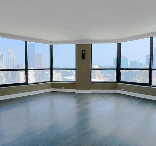 405 N Wabash Ave Unit 5109, Chicago, IL 60611 - unfurnished room featuring dark wood finished floors, a view of skyline, and healthy amount of natural light