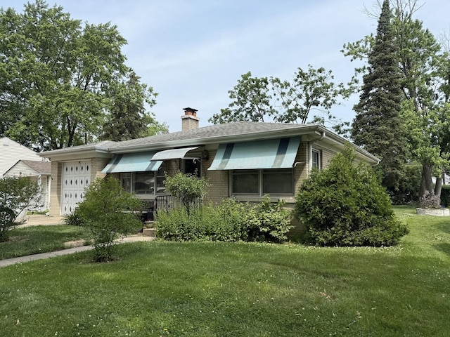 616 E Prairie Ave, Des Plaines, IL 60016 - view of front of home with a garage, brick siding, a front yard, and a chimney