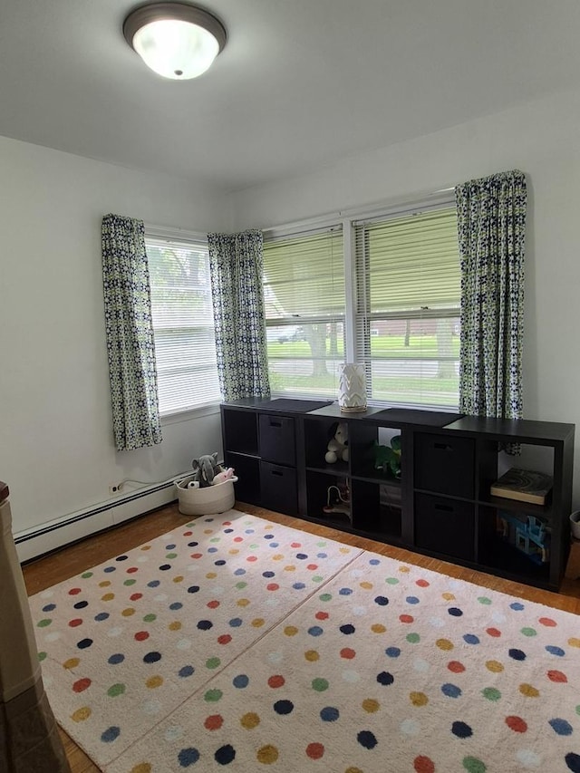616 E Prairie Ave, Des Plaines, IL 60016 - spare room featuring baseboard heating and wood finished floors
