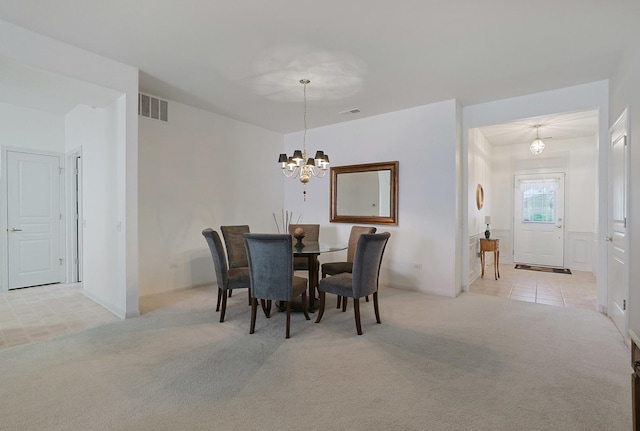 11768 Chatfield Xing, Huntley, IL 60142 - dining area featuring light colored carpet, a chandelier, and light tile patterned floors