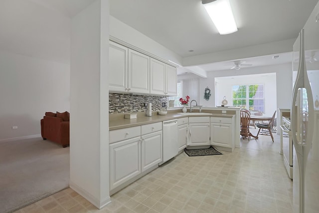 11768 Chatfield Xing, Huntley, IL 60142 - kitchen with white appliances, a peninsula, white cabinetry, light countertops, and light colored carpet